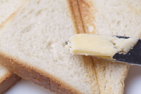 Toast and knife with butterの写真素材