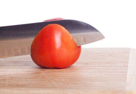 Tomato and knife on cutting board