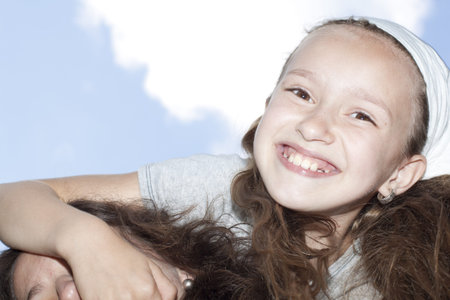 Little girl against blue sky