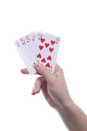 Womans' hand's holding playing cards. Royal flush. Isolated.の写真素材