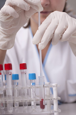 Woman in coat is doing laboratory research.