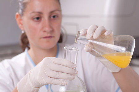 Woman examine bottle with chemical in laboratory