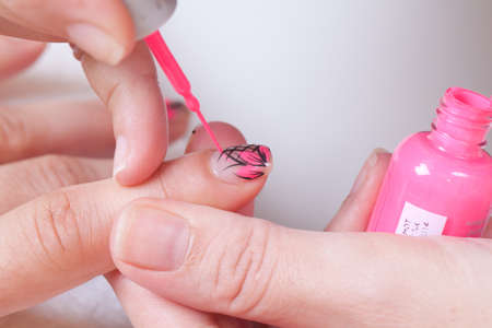 Professional manicure procedure in beauty salon. Woman hands close up. の写真素材