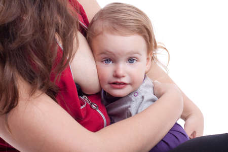 Mother breast feeding her little girlの写真素材
