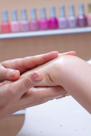 Professional manicure procedure in beauty salon. Hands close up.の写真素材