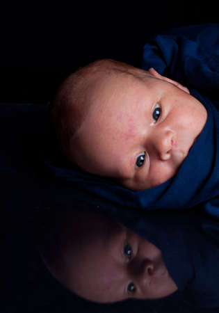 Newborn baby boy in blue slingの写真素材