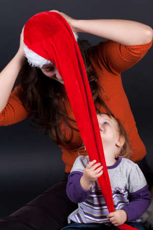 Mother and daughter playing at christmas. Studio shoot.の写真素材