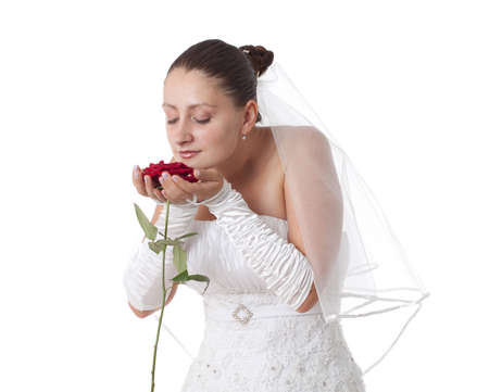 Bride in white holding a red rose. Isolatedの写真素材