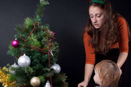 Mother and daughter playing at christmas. Studio shoot.の写真素材