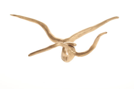 Wooden sculpture gold colored. Piece of art isolated on whiteの写真素材