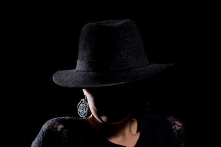 Woman portrait with black hat. Studio shot.の写真素材