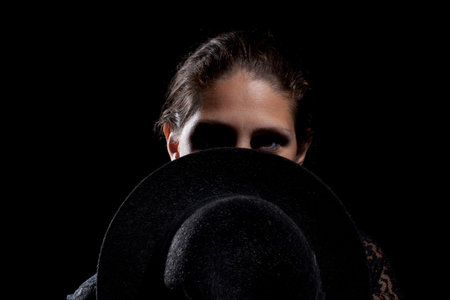 Woman portrait with black hat. Studio shot.の写真素材