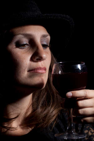 Woman with glass full of wine. Studio shot.の写真素材