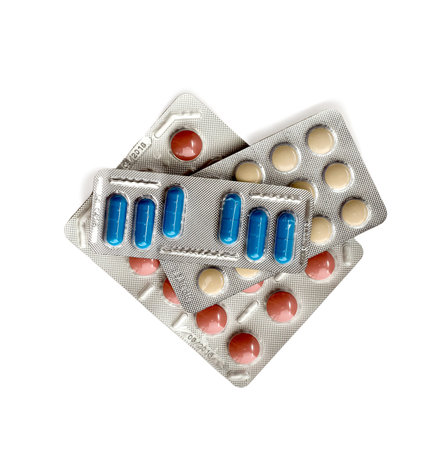 Packs of pills isolated on white. stack of three different multicolored blisters. white, blue and...