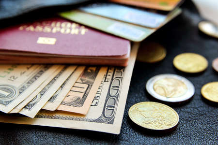 credit cards, passport, money, peeking out from the bag, close-up view on black leather background.の写真素材
