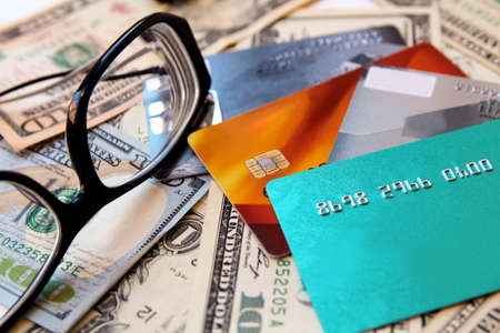American dollars, credit cards and eyeglasses, close-up.の写真素材