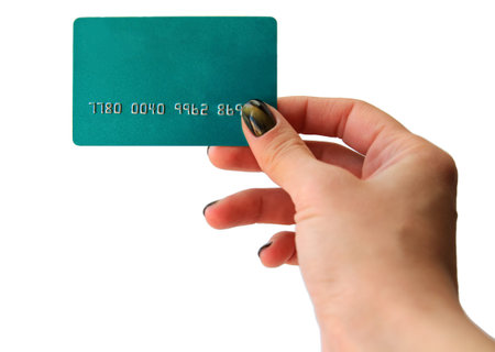 Woman's hand holding blue blank plastic credit card, isolated on white.