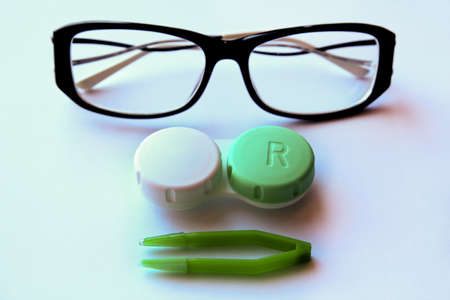 eyeglasses and eye contact lenses on white background.の写真素材