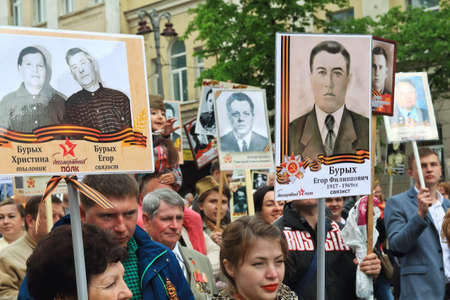 KURSK, RUSSIA - May 9,2017: Immortal Regiment procession in Victory Day- hundreds of people marching toward the Red Square with flags and portraits.のeditorial素材