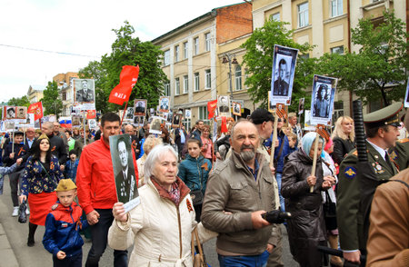 KURSK, RUSSIA - May 9,2017: People in the crowd participating in Immortal Regiment procession in Victory Day. Thousands of people marching toward the Red Square with flags and portraits.のeditorial素材