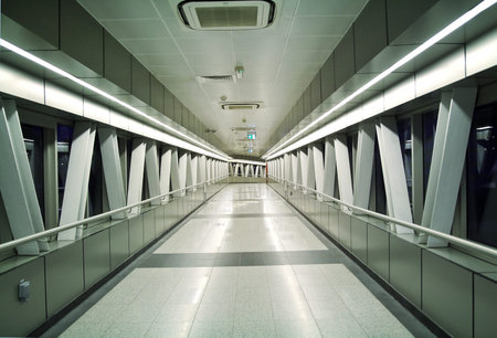 Modern pedestrian overpass air footbridge at night with perspective.の写真素材
