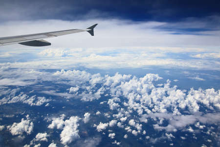 Beautiful clouds, land and wing of an airplan, view from the airplane window.の写真素材