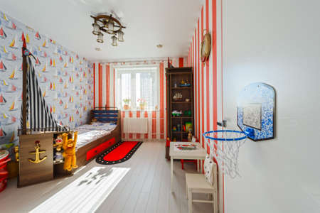Fragment Interior of modern children's room with red furniture and toysの写真素材