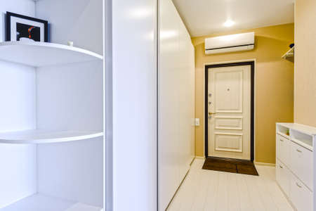 Fragment of interior apartment hallway and entrance door and air conditioningの写真素材