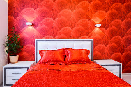 Comfortable and cozy white and red bedroomの写真素材