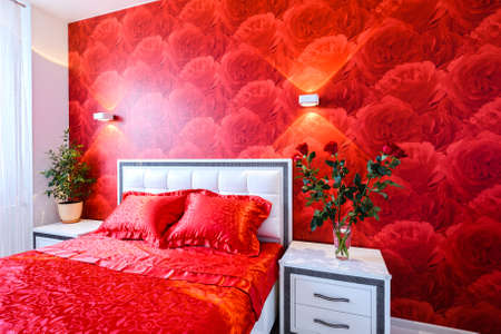 Comfortable and cozy white and red bedroomの写真素材