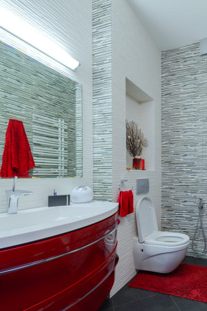 Interior beautiful bathroom in a modern style in gray and red tones