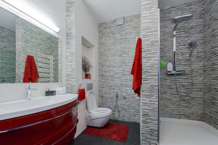 Interior beautiful bathroom in a modern style in gray and red tonesの写真素材