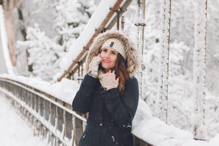 Winter portrait of a beautiful woman in the snowfallの写真素材