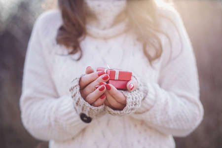 Young woman holding a valentine's day gift in her handsの写真素材