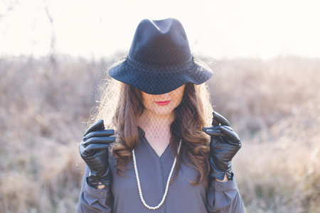 Portrait of a young woman wearing a hat