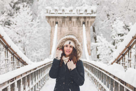 Winter portrait of a beautiful woman in the snowfallの写真素材