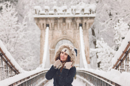Winter portrait of a beautiful woman in the snowfall