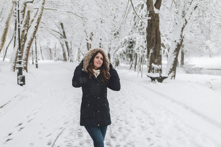 Winter portrait of a beautiful woman in the snowfall