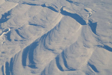 Snow background. Snow dunes in a sunny dayの写真素材