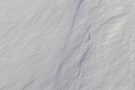 Snow background. Snow dunes in a sunny dayの写真素材
