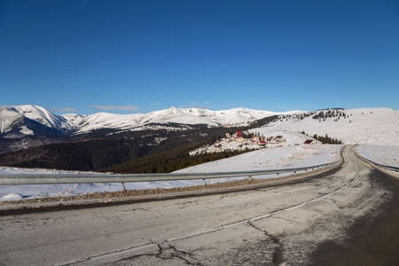 Mountain road covered with snow, closed for the circulationの写真素材