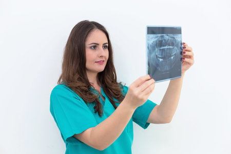 Female doctor or looking at x-ray. Dentist woman studying dental radiography