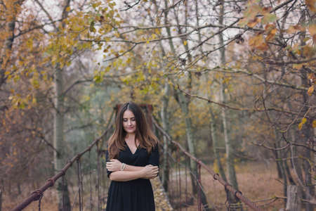 Autumn portrait of a young woman reading a book in the natureの写真素材