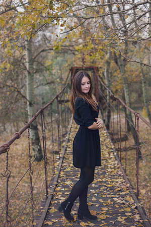 Autumn portrait of a young woman reading a book in the natureの写真素材