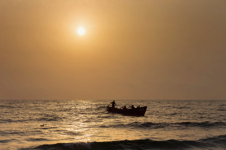 Fishermen silhouettes on boat, at sunriseのeditorial素材
