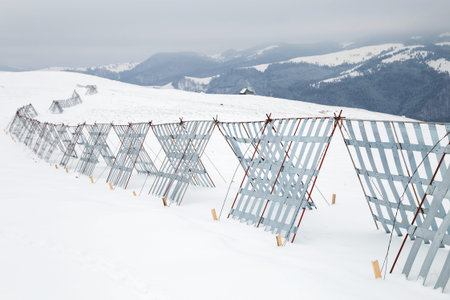 Snow fences on mountain roadの写真素材