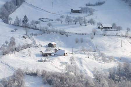 Winter frosty landscape of the beautiful Transylvanian village, Bran, with fresh snow, at the foot...