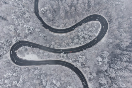 Aerial winter view of the curvy mountain road, in Poiana Brasovの写真素材