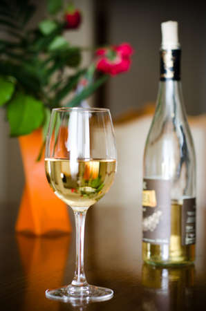 Wine glass and wine bottle on a romantic backgroudの写真素材
