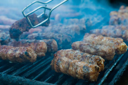 Meat rolls caled mici  being cooked on the grillの写真素材